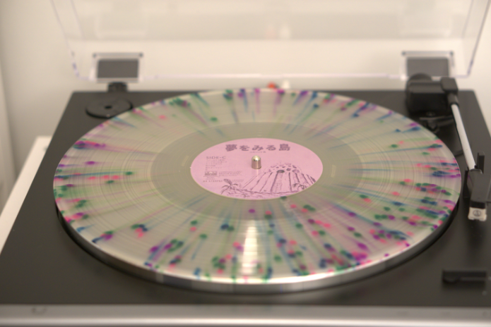 A clear vinyl records. Speckled with pink, green, and blue dots